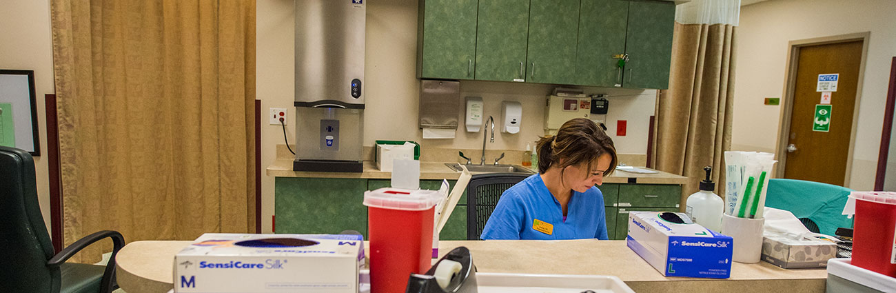 Nurse working behind counter